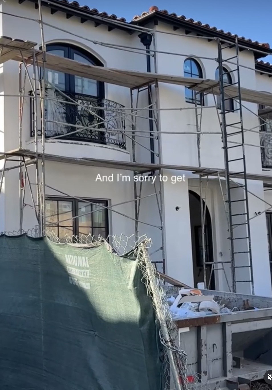 Exterior work in progress with scaffolding around the new second story