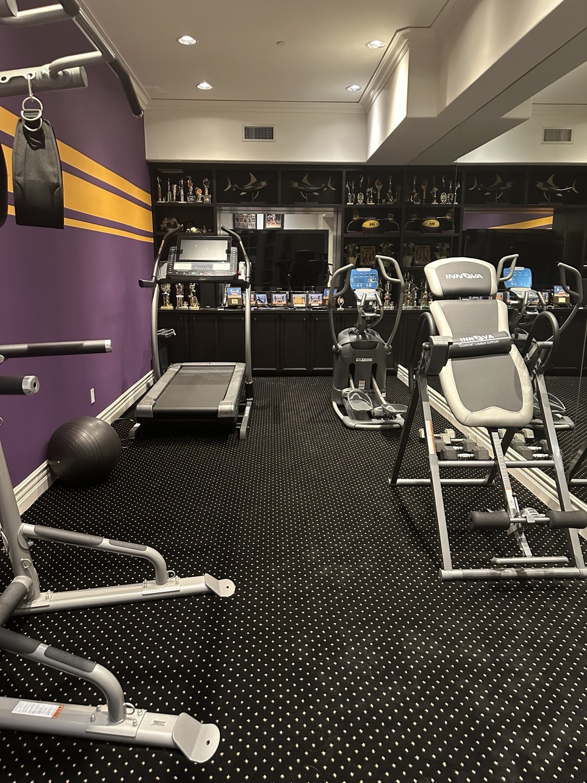 Home gym with mirrored wall and exercise equipment