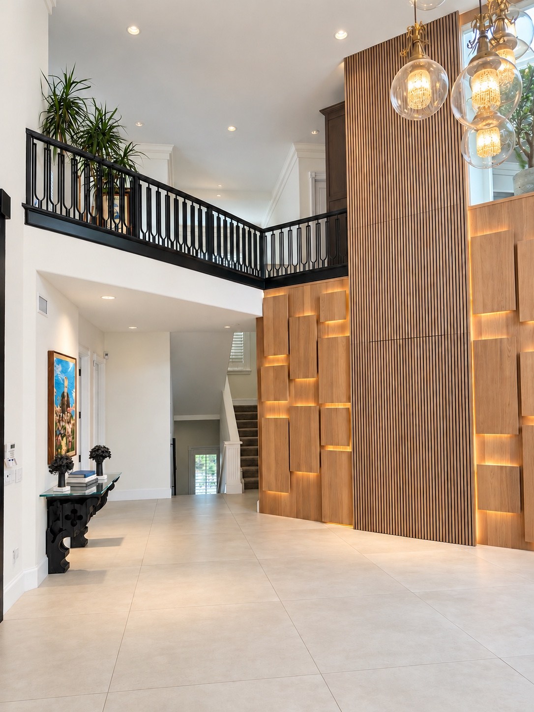 Double-height foyer with illuminated wood feature wall