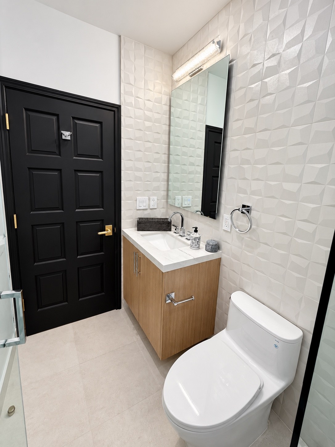 Bathroom with a floating wood vanity and dimensional tile