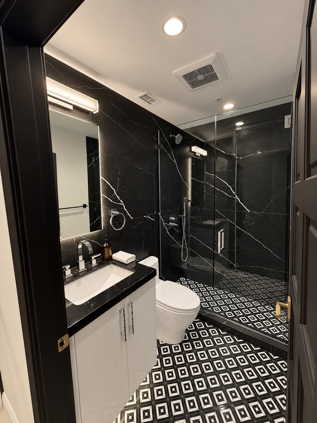 Bathroom with dark stone walls and geometric floor tile